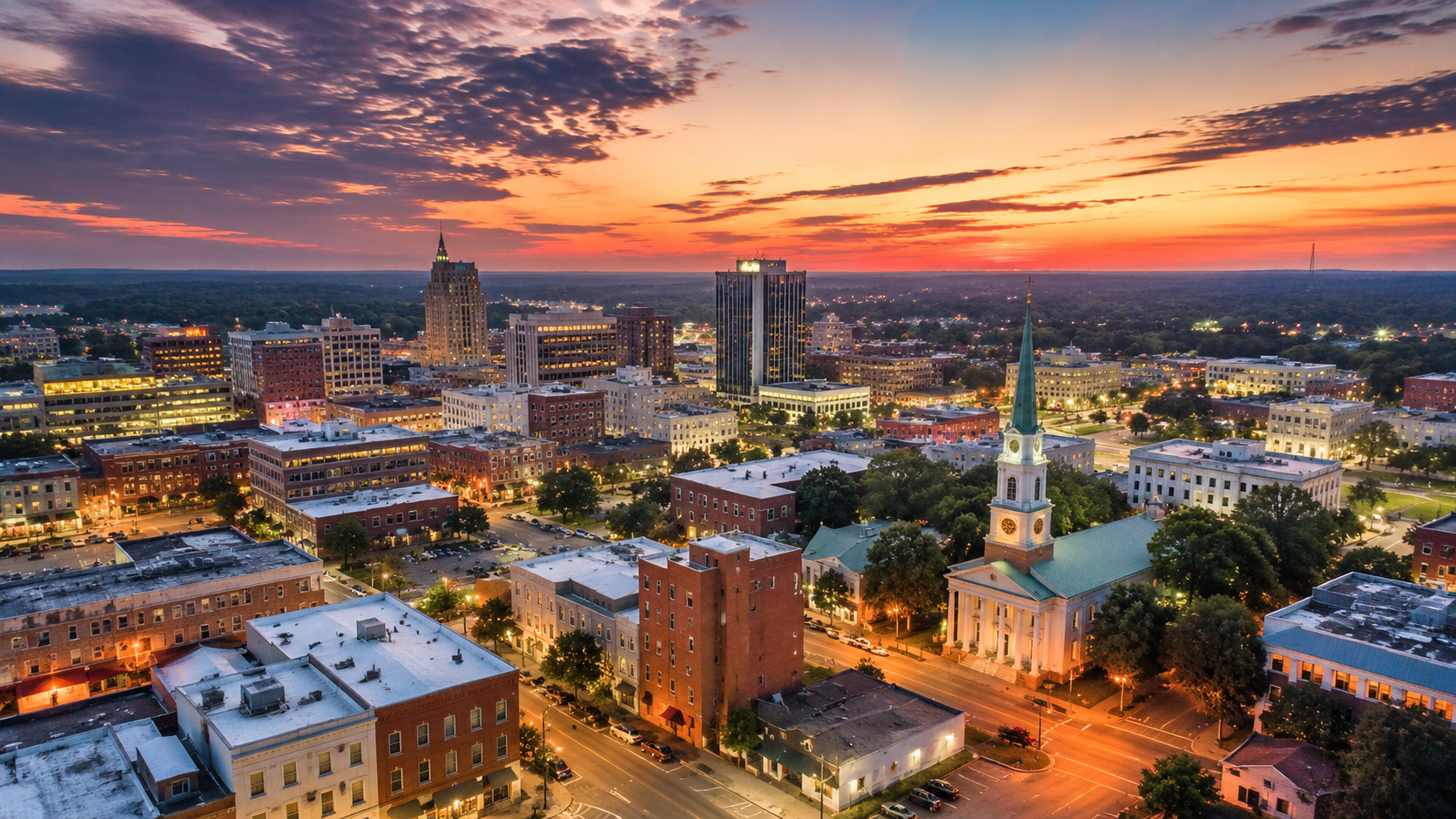 Aerial view of downtown Macon, Georgia at sunset with the historic First Presbyterian Church spire and city skyline